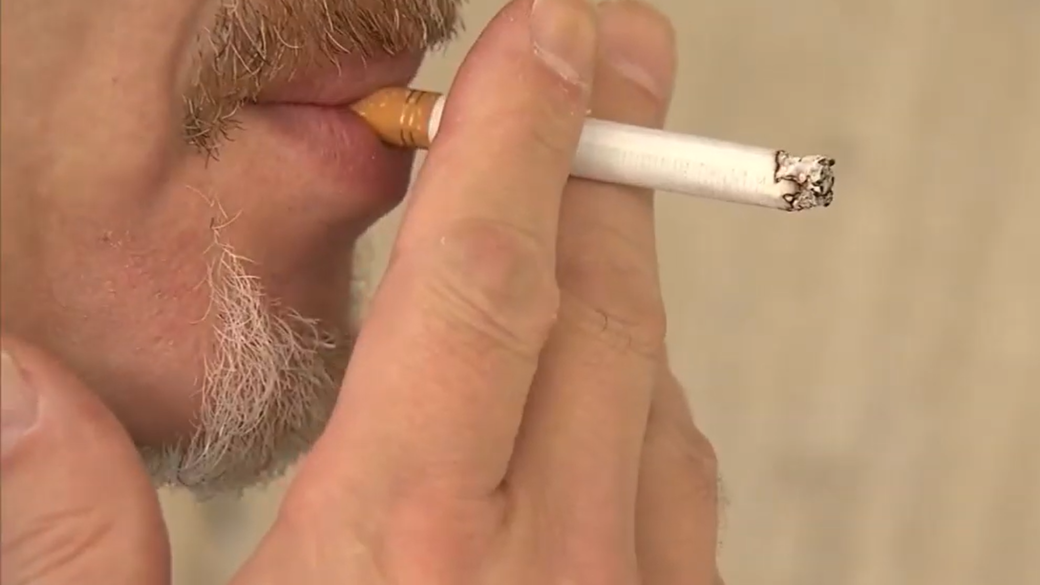 man smoking in an apartment