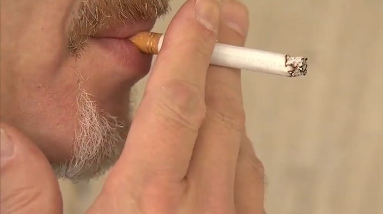 man smoking in an apartment