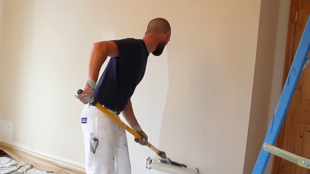 A person painting apartment walls