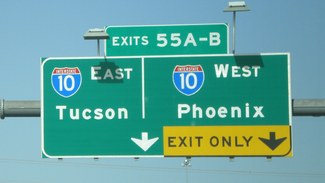 Road sign with Tucson on the left and Phoenix on the right
