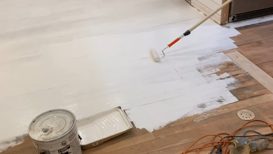 painting wooden floor with white paint using roller